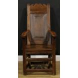 An 18th century and later oak and fruitwood caquetoire or panel-back armchair, possibly Scottish,