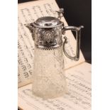 A Victorian silver mounted hobnail-cut clear glass claret jug, hinged cover surmounted by a lion