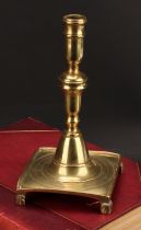 A Spanish brass tray base socket candlestick, knopped pillar, domed socle, fluted feet, 23cm high,