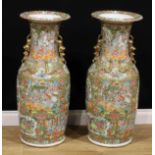 A pair of large Chinese famille rose floor vases, painted in the Cantonese taste with a profusion of