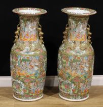 A pair of large Chinese famille rose floor vases, painted in the Cantonese taste with a profusion of