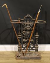 A Victorian cast iron walking stick or umbrella stand, cast with a portrait amongst fruiting