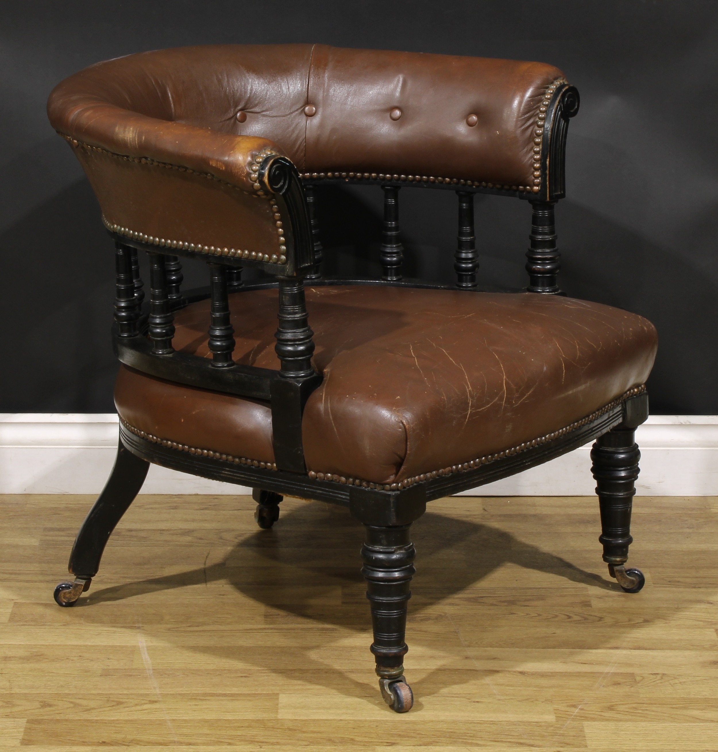 A late Victorian ebonised club or library chair, stuffed-over upholstery, turned forelegs, 69cm - Image 2 of 4