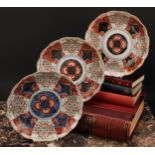 A pair of Japanese shaped circular plates, painted in the Imari palette, 21.5cm diam, Meiji
