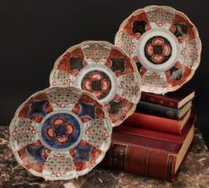 A pair of Japanese shaped circular plates, painted in the Imari palette, 21.5cm diam, Meiji