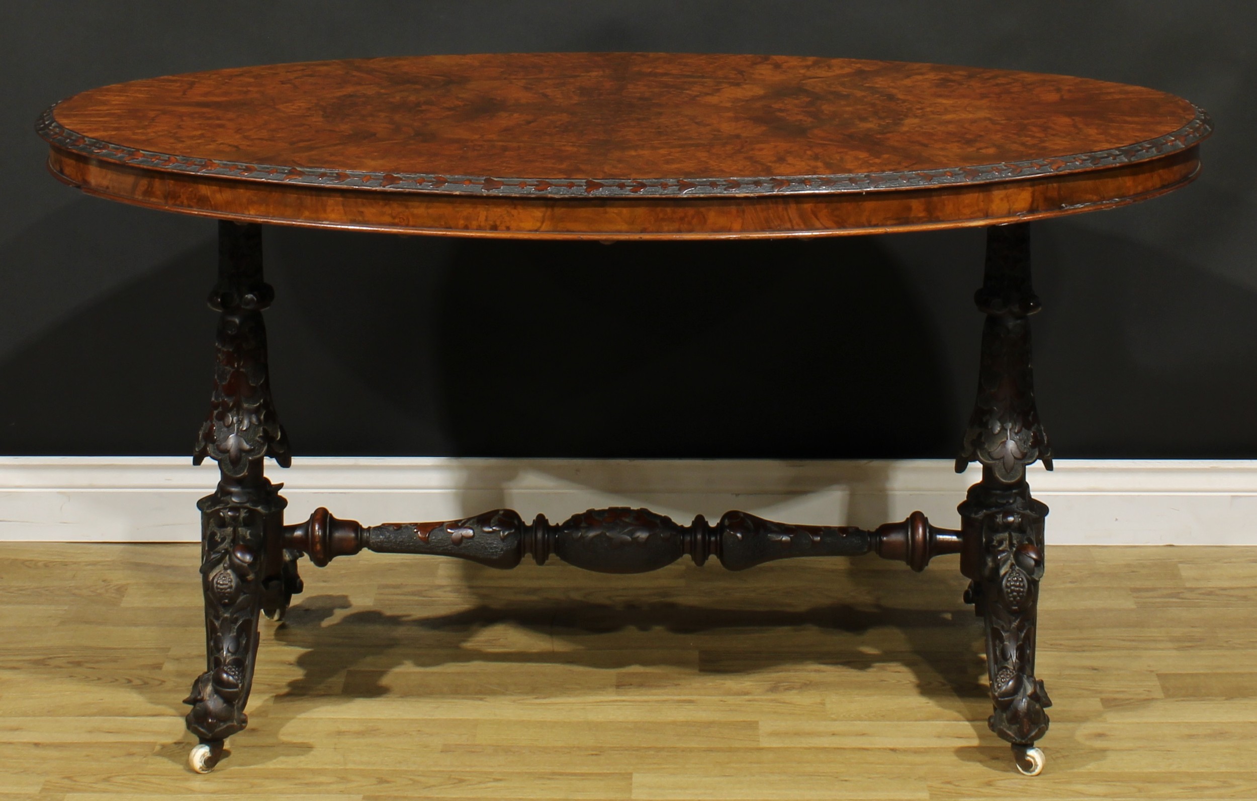 A Victorian Irish walnut and mahogany centre table, oval quarter-veneered top with carved edge, - Image 2 of 3