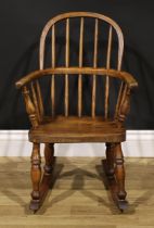 A 19th century ash and elm child’s Windsor rocking chair, 68cm high, 44cm wide