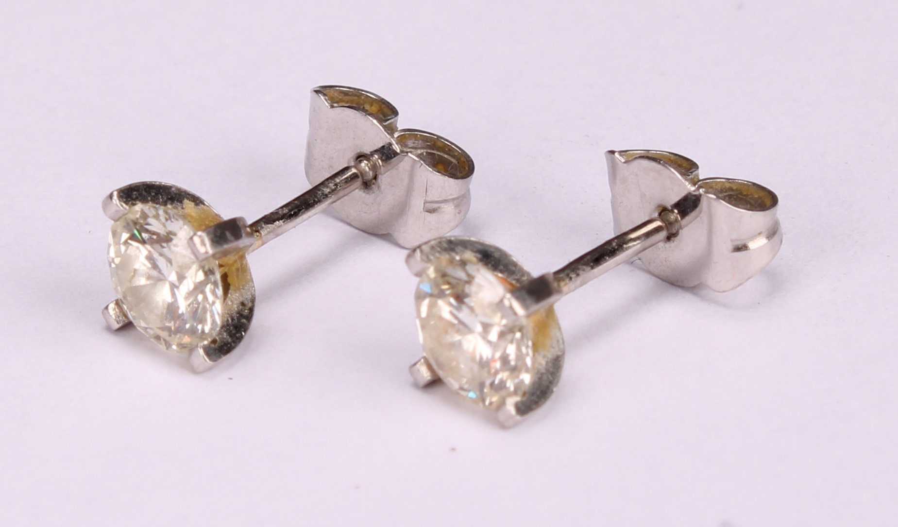 A pair of diamond stud earrings, the round brilliant cut stones claw set, platinum mounted, 1.7ct - Image 4 of 5