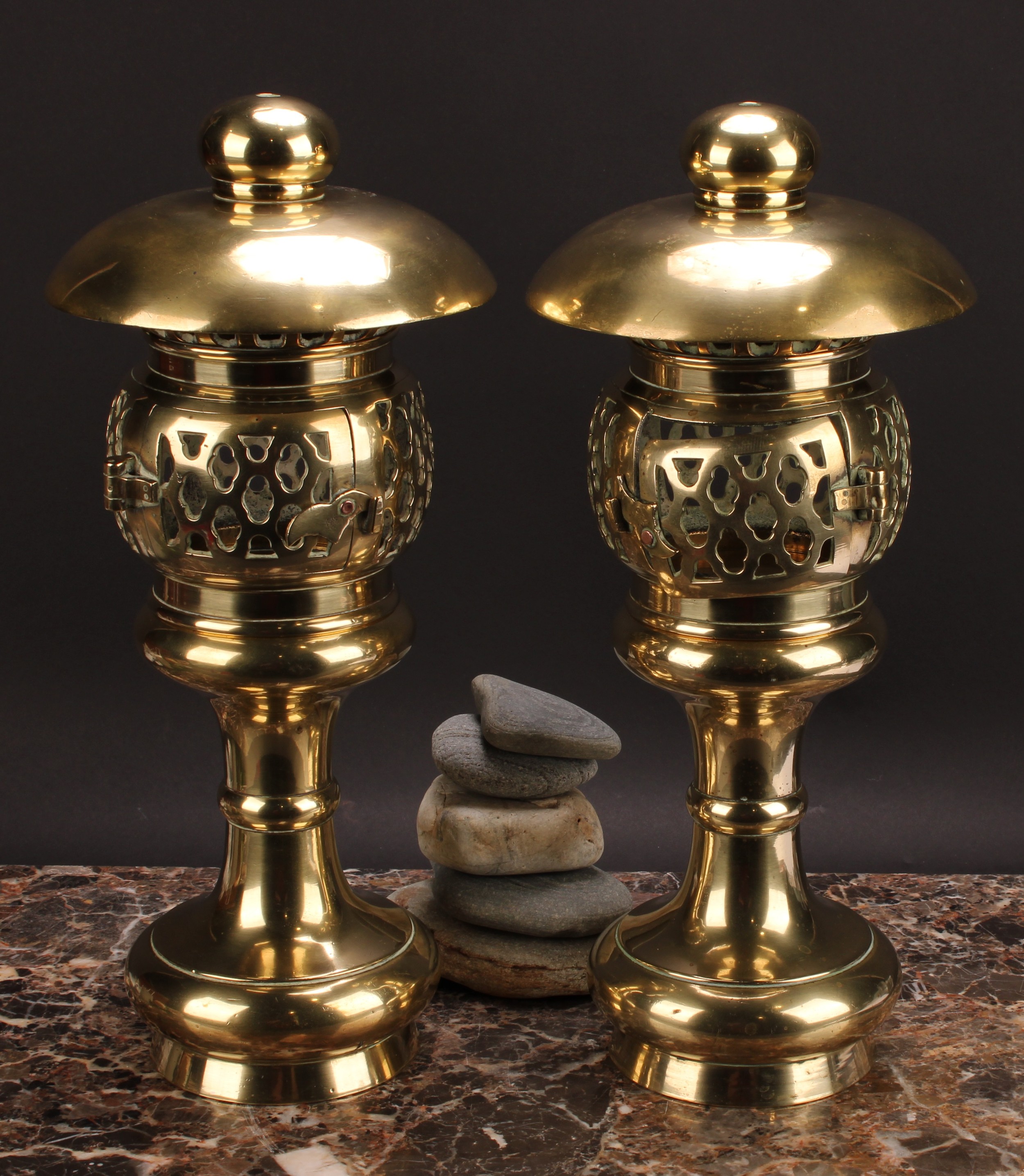 A pair of 19th century brass pagoda temple lamps, each with domed oversailing canopy above a pierced