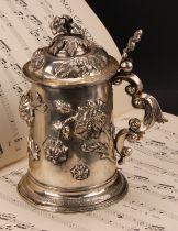A 19th century Austrian silver tankard, chased with stylised flowers, leafy scroll handle, skirted