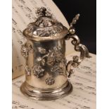 A 19th century Austrian silver tankard, chased with stylised flowers, leafy scroll handle, skirted