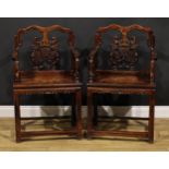 A pair of Chinese hardwood taishi armchairs, each with a shaped back carved with ruyi scepters,