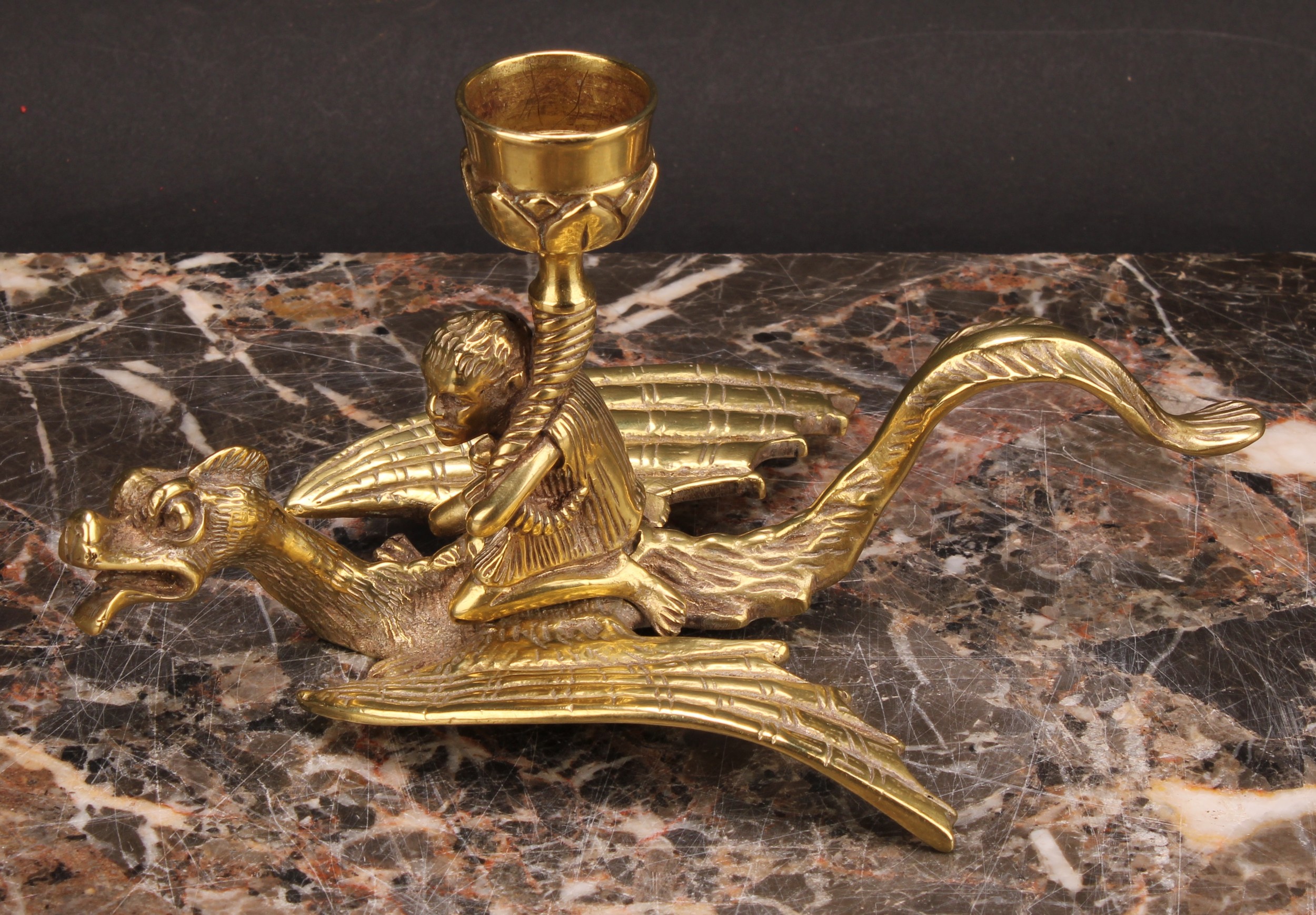 A 19th century brass chamberstick, cast as a figure riding a dragon, 9cm high - Image 2 of 4