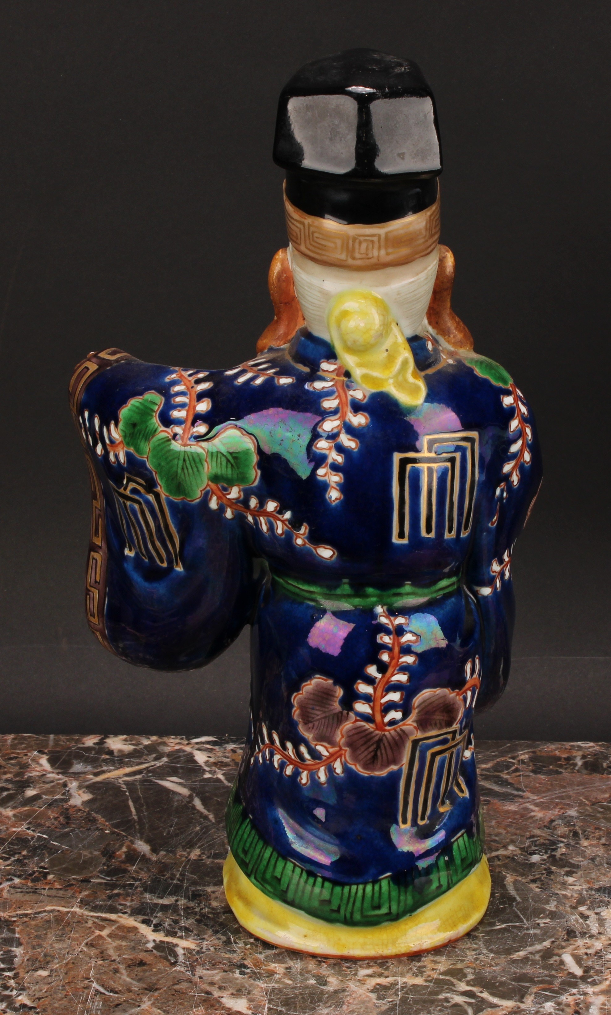 A Japanese porcelain figure, of an elder holding a fan, painted in polychrome and picked out in - Image 5 of 6