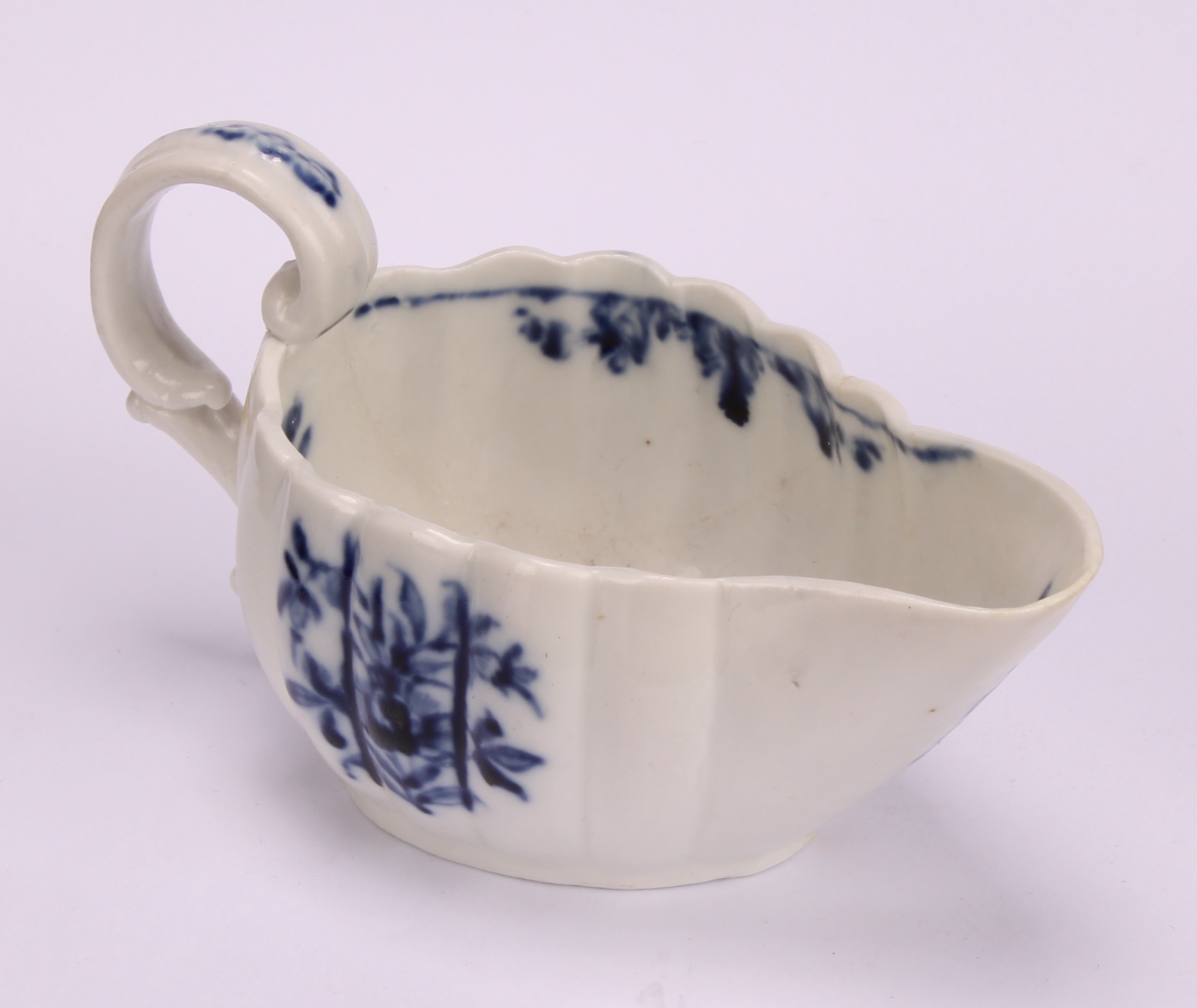 A Cookworthy Bristol butter boat, of fluted form, painted in underglaze blue with flowers, 11cm - Image 3 of 5