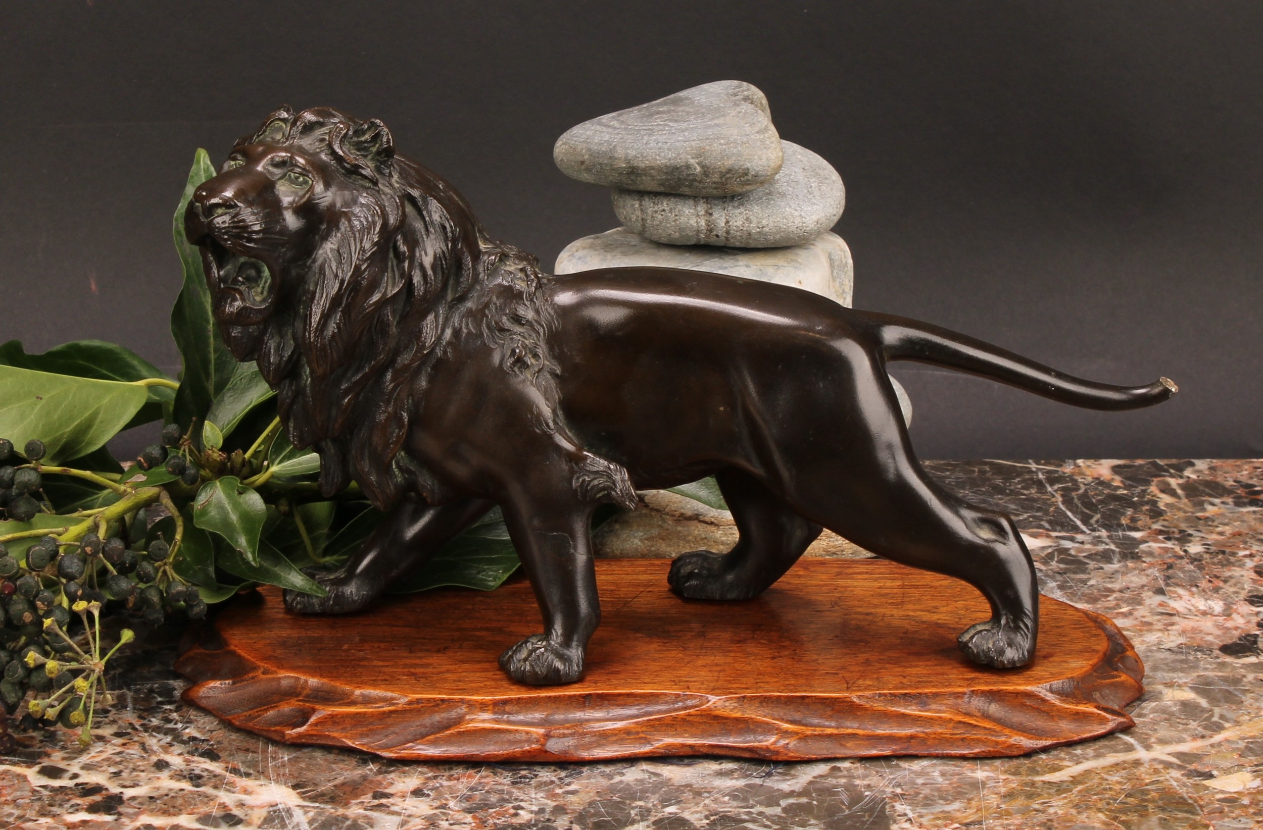 Japanese School (Meiji period), a brown patinated bronze, of a lion, 25.5cm long, signed, Meiji