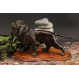 Japanese School (Meiji period), a brown patinated bronze, of a lion, 25.5cm long, signed, Meiji