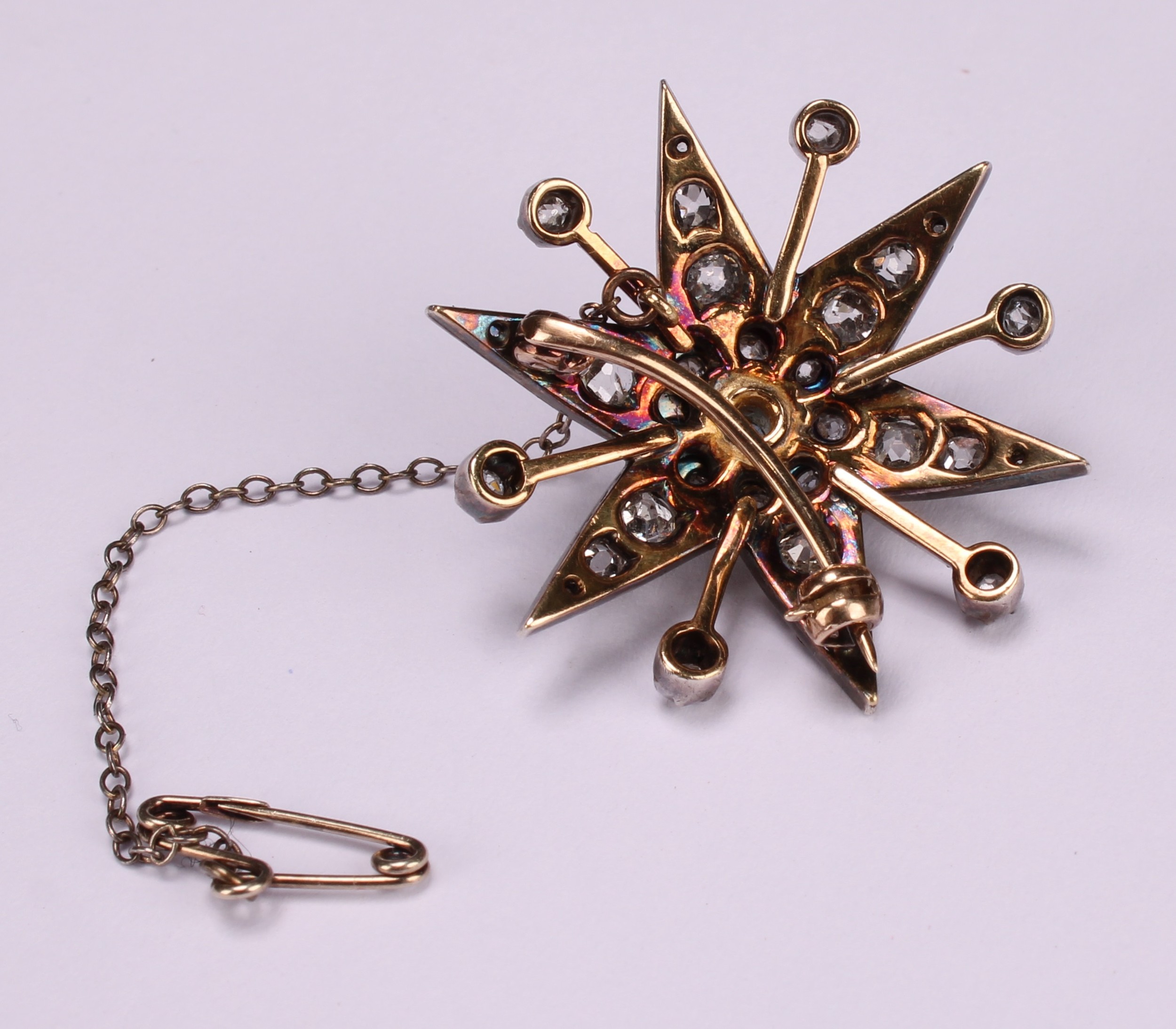A diamond radiating starburst brooch, set with old cut stones, the central stone a faceted - Image 3 of 3