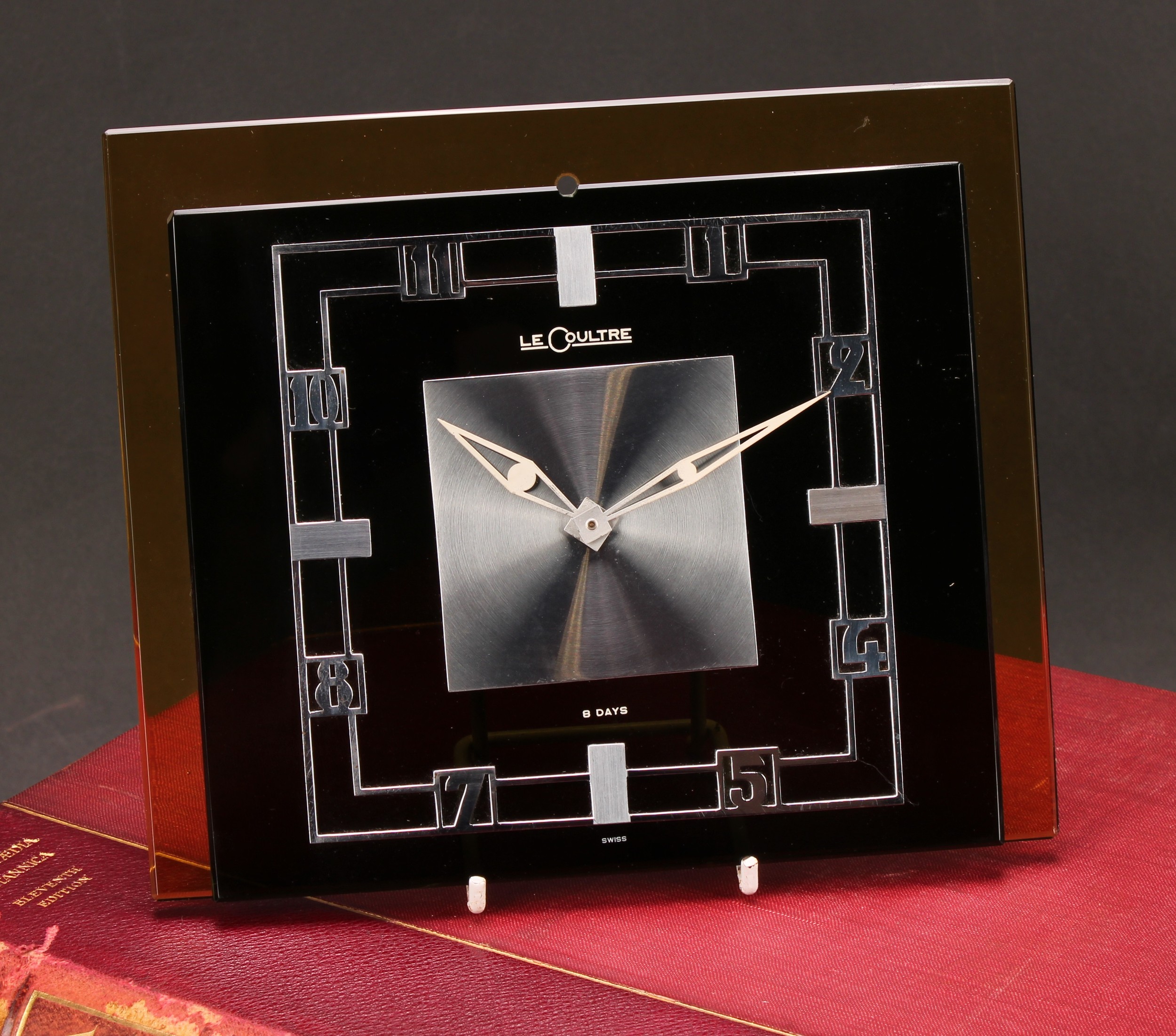 A Jaeger Le Coultre Art Deco clock, black glass rectangular dial applied with chrome Arabic numerals