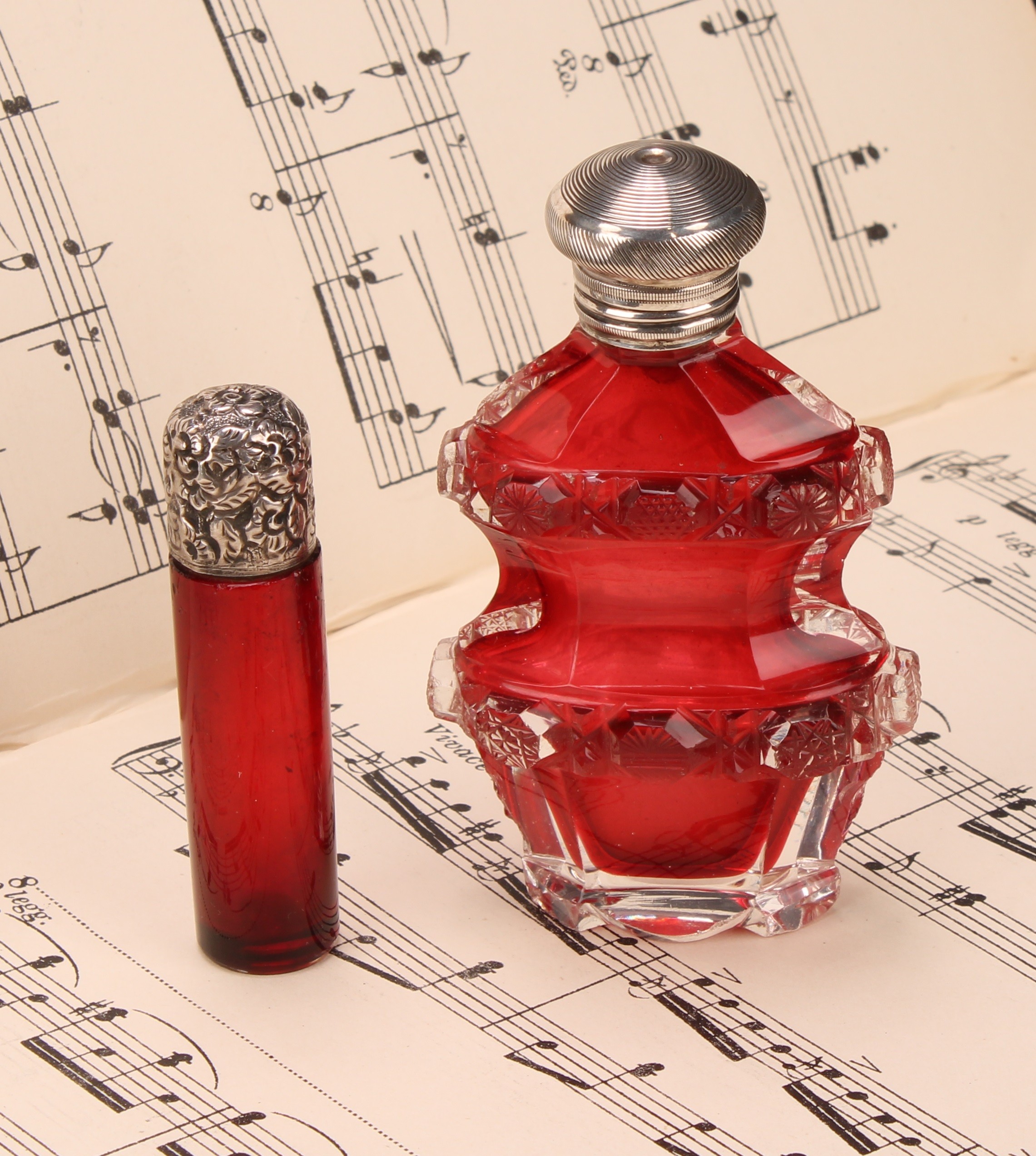 A 19th century silver coloured metal mounted cylindrical cranberry glass scent bottle, the hinged