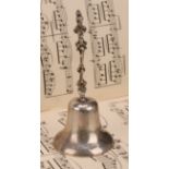 A George V silver table bell, cast figural handle, 14cm high, Crisford & Norris, Birmingham 1911