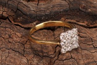 A diamond cluster ring, square set with nine round brilliant cut diamonds, total estimated diamond