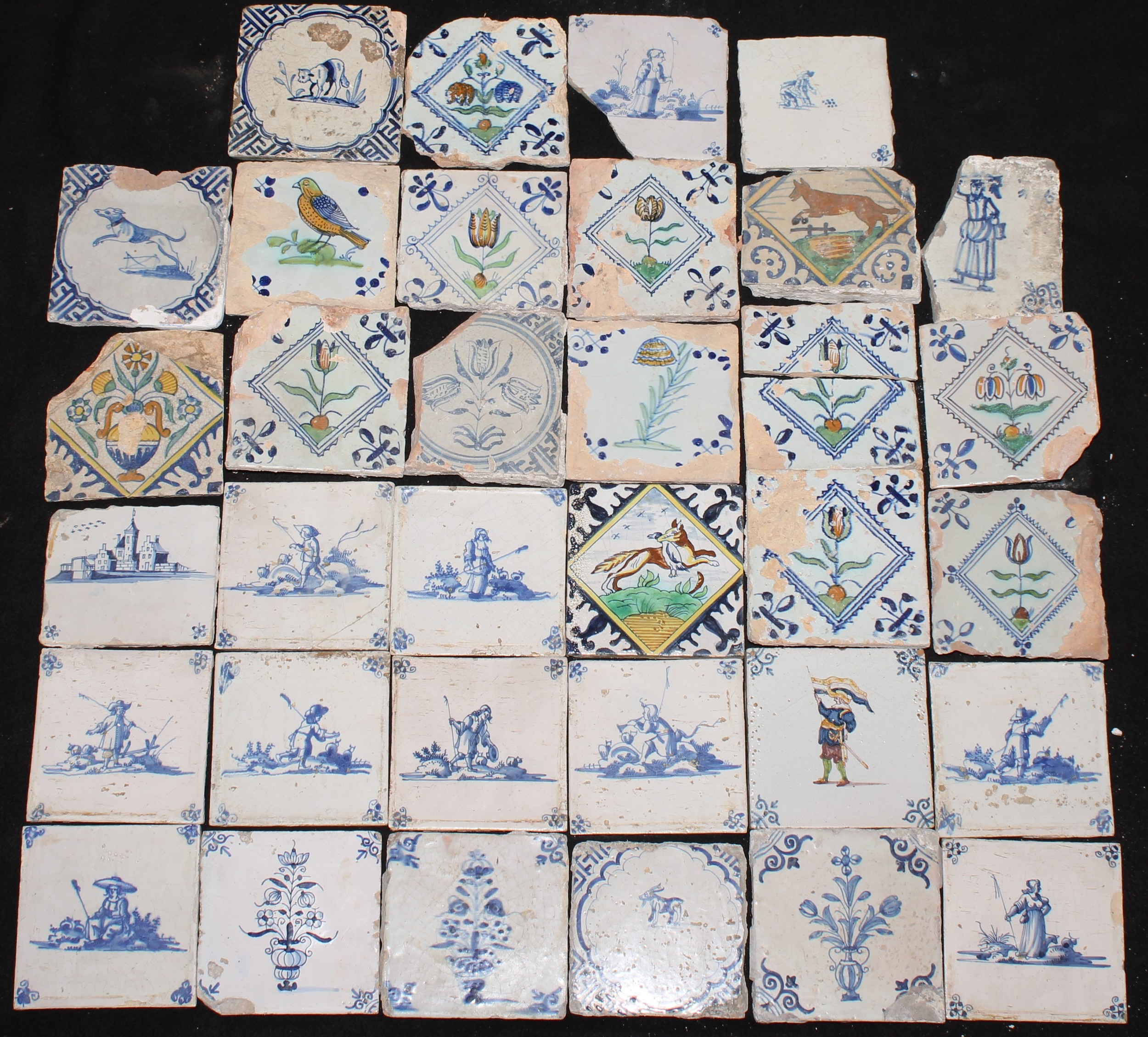 A collection of 18th and 19th century Delft tiles, including polychrome, figures, flora and fauna,