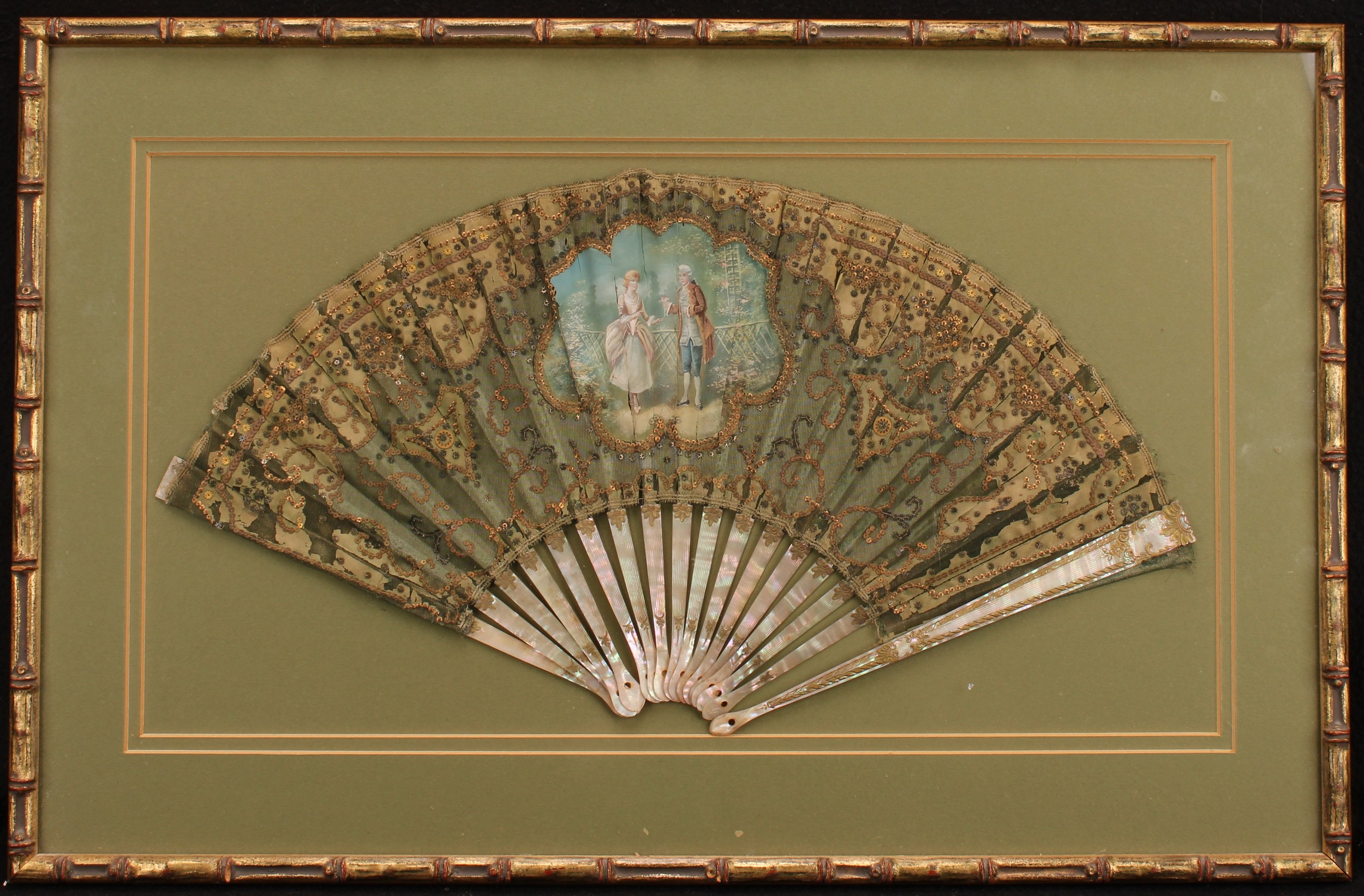 A 19th century French mother of pearl and silk fan, painted with a courting couple, lacking rivet - Image 2 of 3