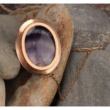 A late 19th century 9ct rose gold Derbyshire Blue John polished oval brooch, the veined panel backed