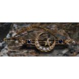 An Edwardian diamond, sapphire, seed pearl and yellow gold coloured metal brooch, centred by a