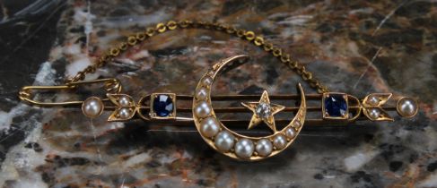 An Edwardian diamond, sapphire, seed pearl and yellow gold coloured metal brooch, centred by a