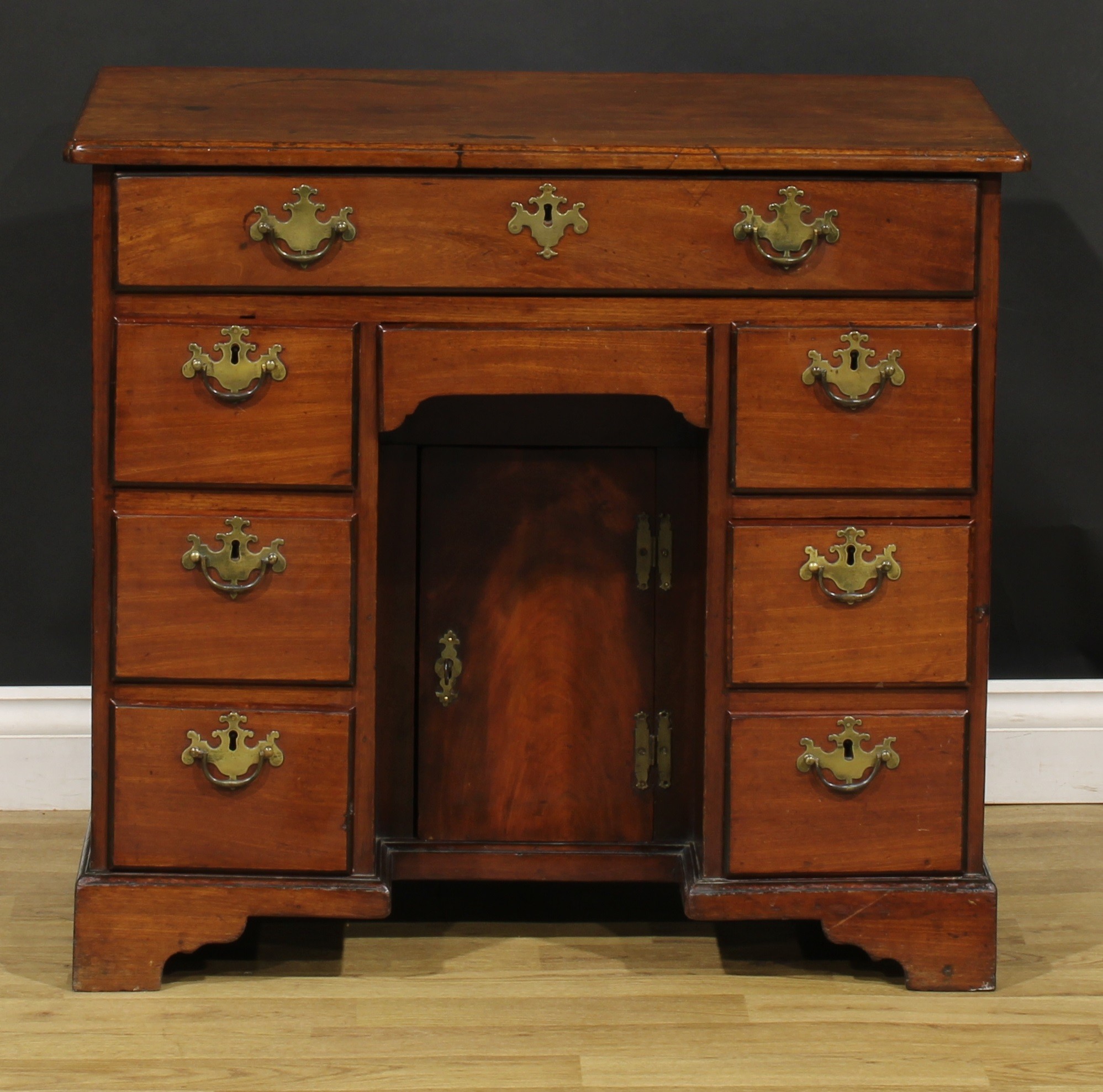 A George III mahogany kneehole desk, slightly oversailing top above an arrangement of eight drawers, - Image 2 of 6