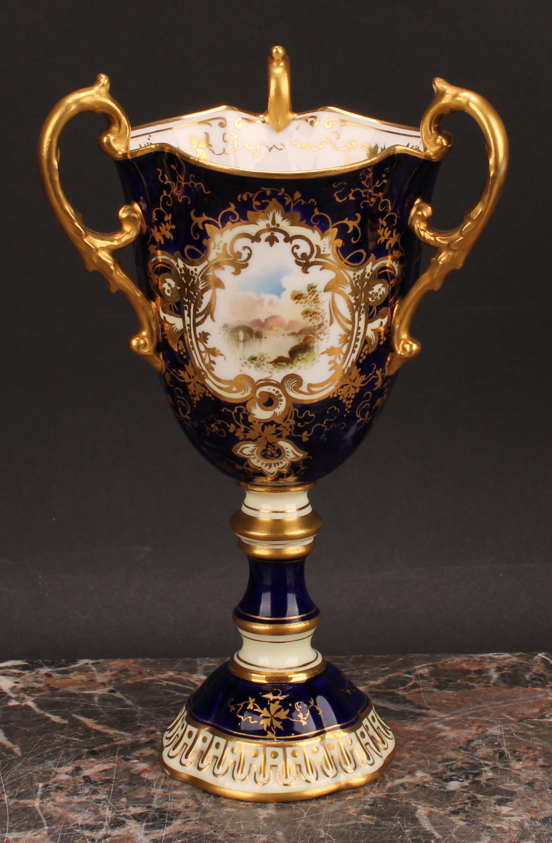 A Coalport three-handled pedestal ovoid cup or vase, painted with a landscape, within an shaped - Image 2 of 5