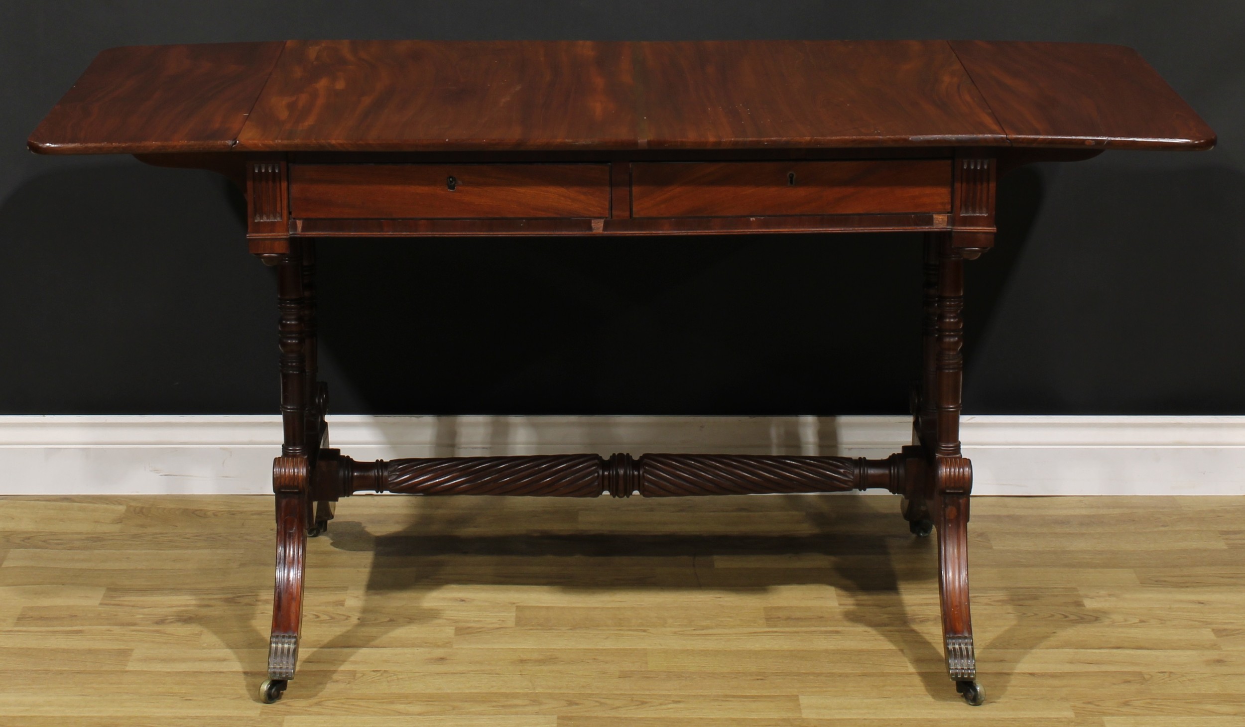 A Regency mahogany sofa table, possibly Irish, rounded rectangular top with fall leaves above a pair - Image 3 of 7