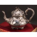 An Irish Victorian Rococo Revival silver melon shaped teapot, chased with flowers and scrolls, 27.