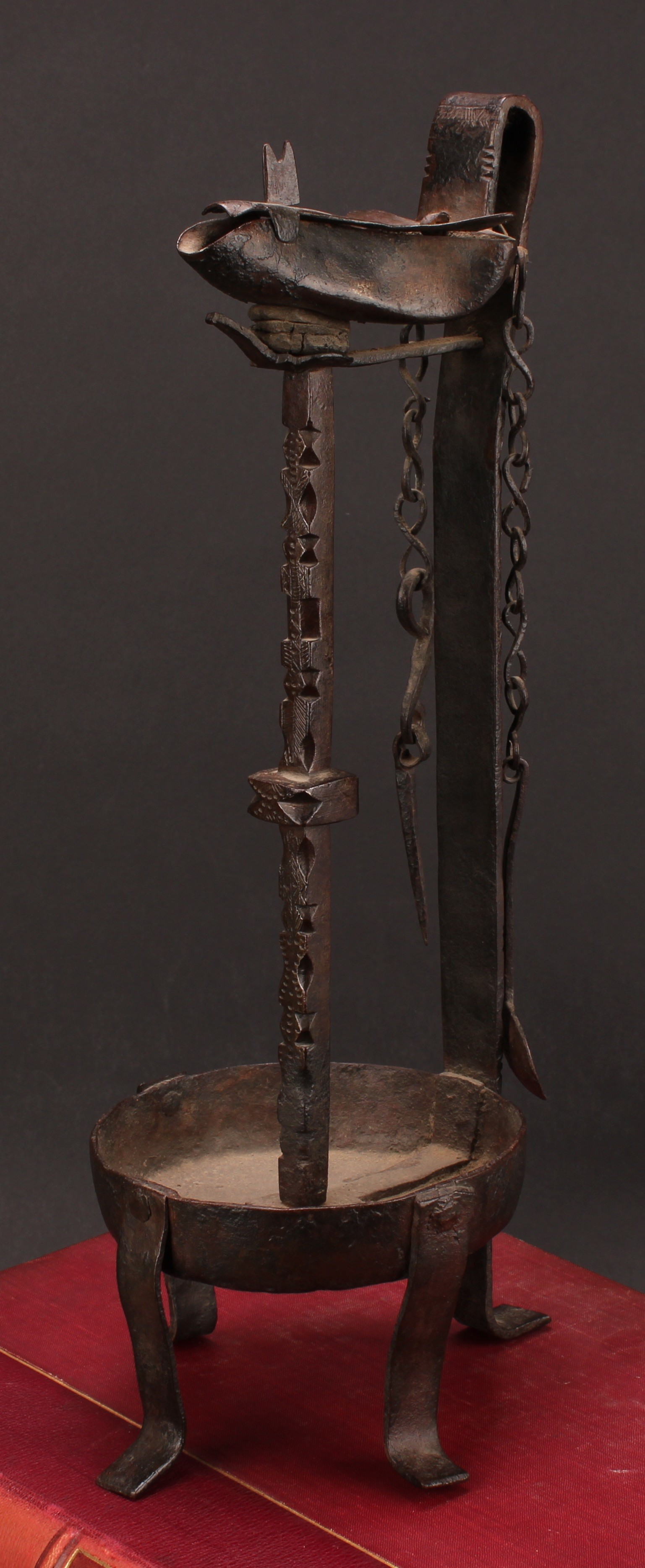 A 19th century wrought iron whale oil lamp, cut steel pillar, 37cm high