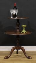 A George III Revival mahogany dumb waiter, dished circular plateaux with carved ribbon border,