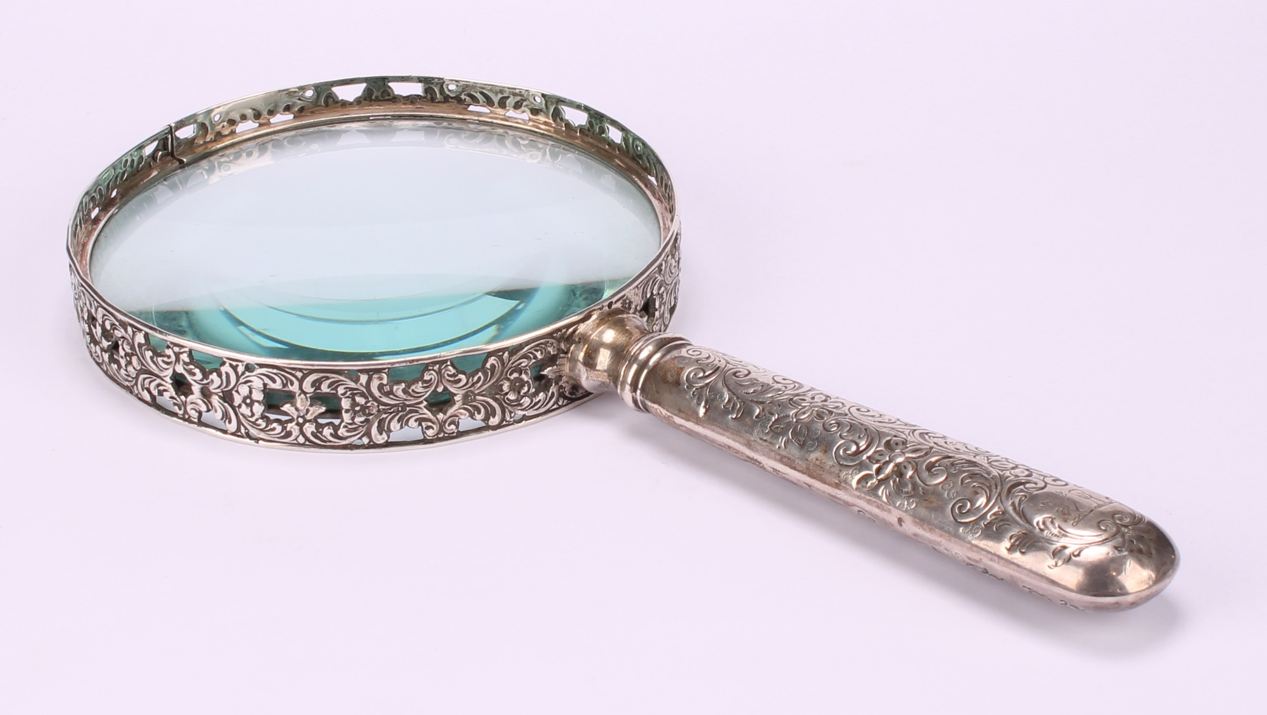 A Victorian silver magnifying glass, the bezel pierced and cast with flowering foliate scrolls, - Image 2 of 4