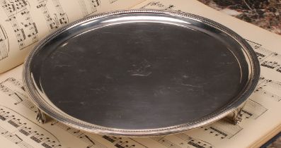 A George III silver circular salver, beaded border, crested, scroll feet, 22.5cm diam, Robert Sharp,
