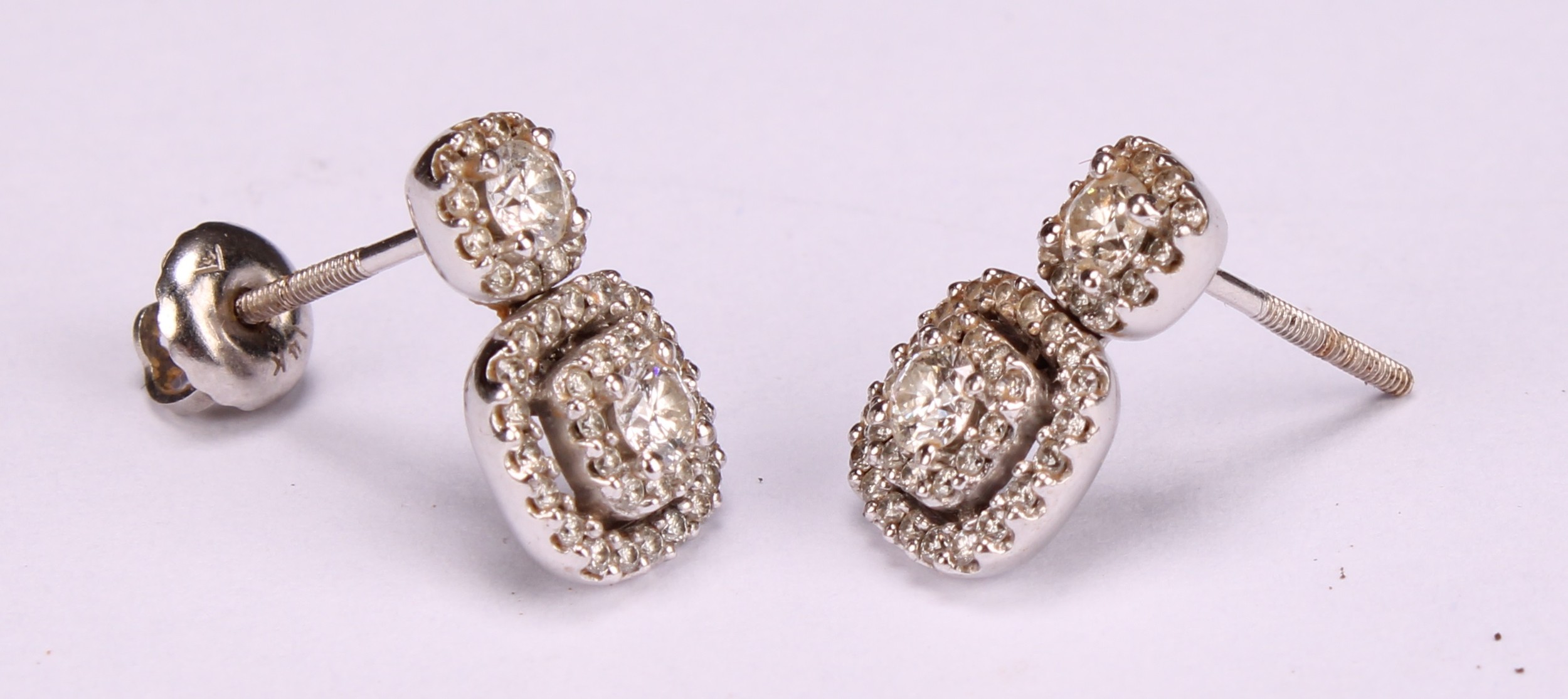 A pair diamond and 10ct white gold drop earrings, set in a halo arrangement of brilliant cut stones, - Image 3 of 4