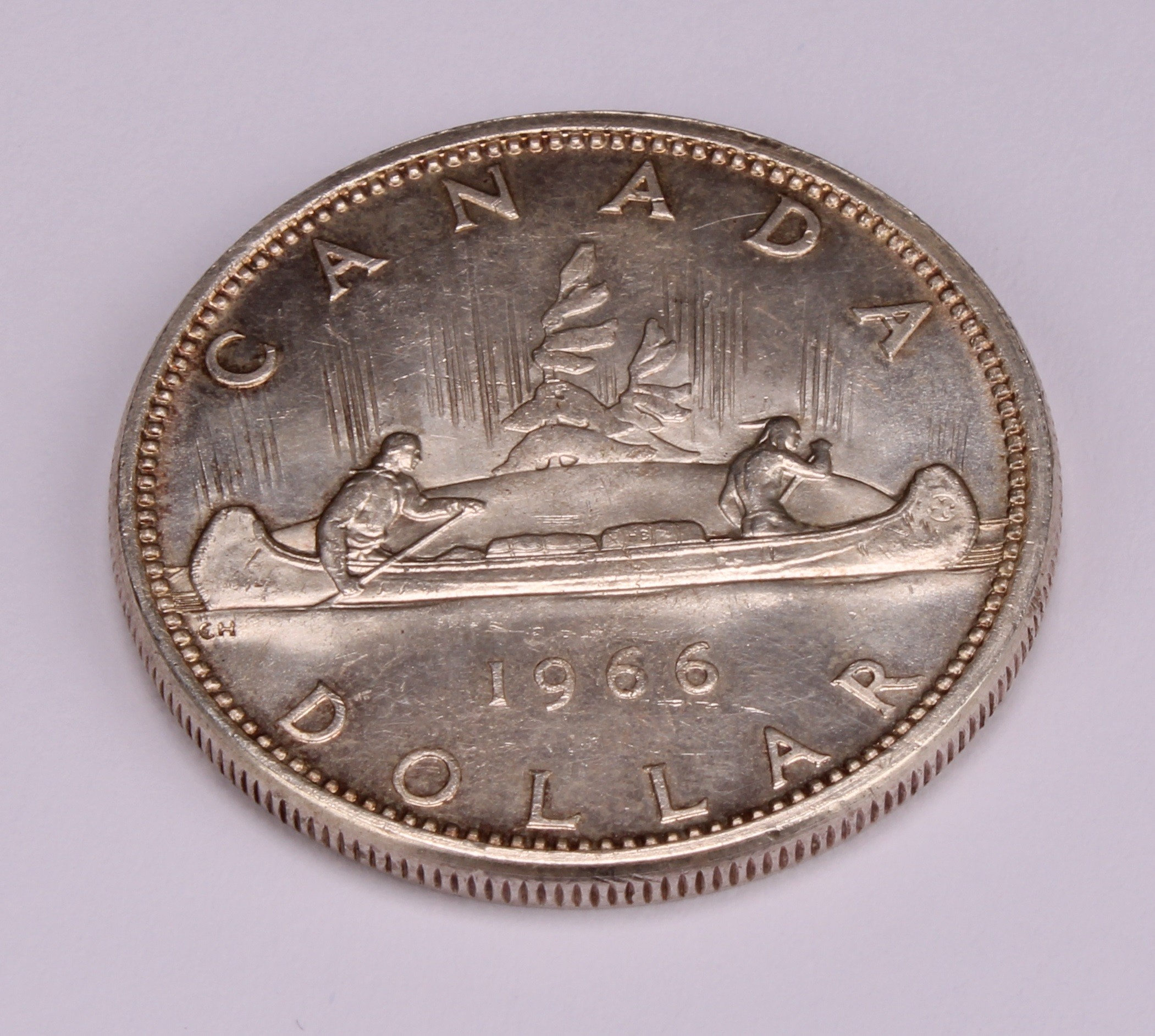 Coins - an Elizabeth II silver Canadian dollar, small beads, 1966 - Image 2 of 3