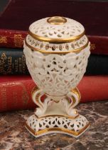 A Graingers Worcester reticulated ovoid pedestal vase and cover, moulded with classical masks, three