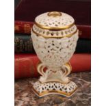 A Graingers Worcester reticulated ovoid pedestal vase and cover, moulded with classical masks, three