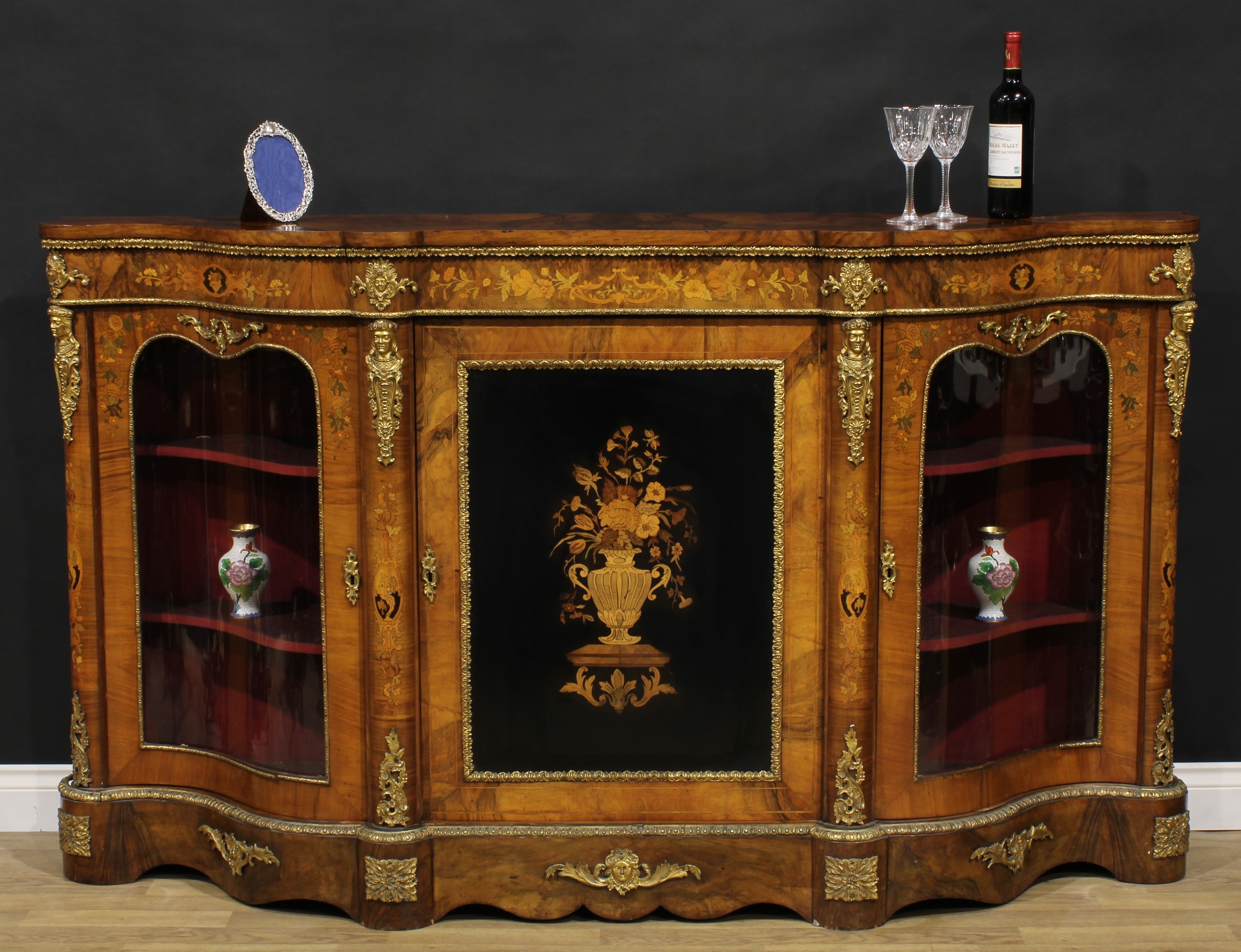 A Victorian gilt metal mounted walnut and marquetry credenza, slightly oversailing top above a