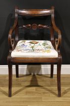 A George IV mahogany elbow chair, scroll arms, reeded borders, drop-in seat, sabre legs, 86cm