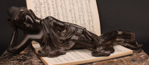 Chinese School, a brown patinated bronze, Buddha, depicted reclining, about to enter Parinirvana,