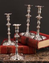 A composed set of four George II/early George III cast table candlesticks, detachable nozzles,