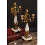 A pair or Louis XVI style gilt metal mounted three branch four light candelabrum, 38cm high