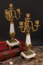 A pair or Louis XVI style gilt metal mounted three branch four light candelabrum, 38cm high
