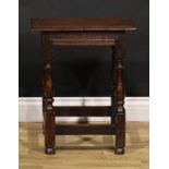 An 18th century oak joint stool, rectangular top with moulded edge, turned legs, rectangular